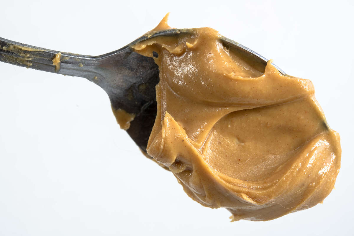 Close up of peanut butter in a spoon phobia arachibutyrophobia