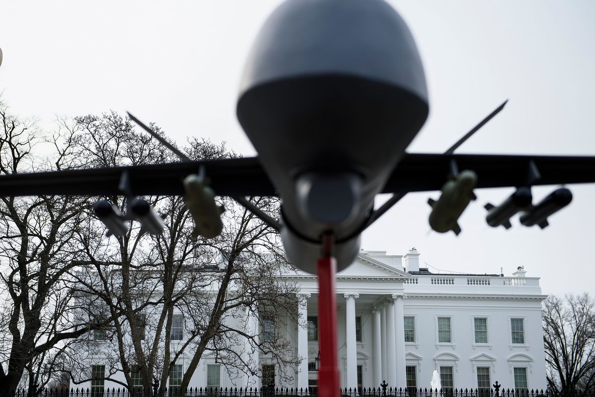 A military drone replica is displayed in front of the White House during a protest against drone strikes