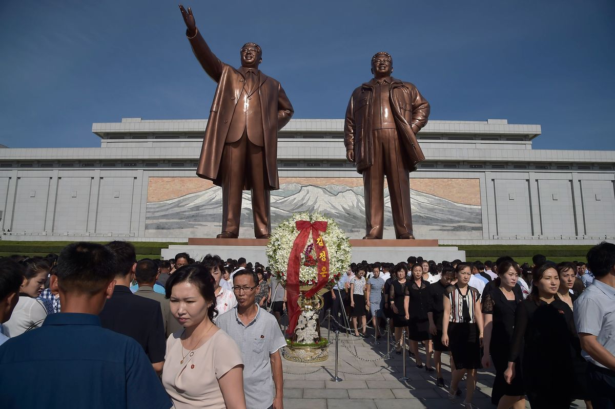 People leave after paying their respects to the late North Korean leaders Kim Il Sung and Kim Jong Il