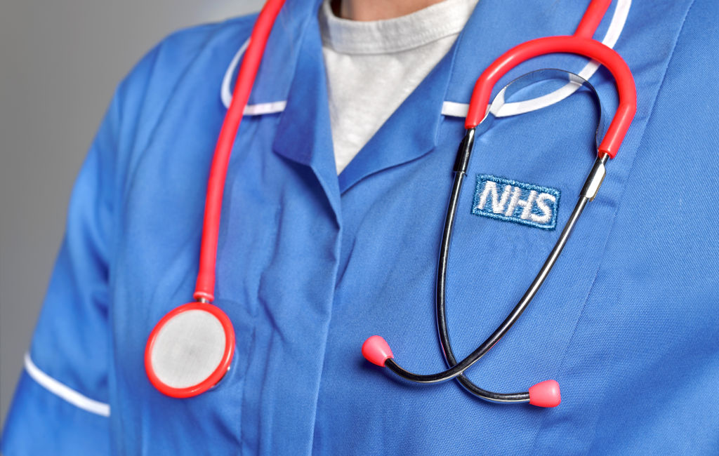 GettyImages-1154960504 In this studio shot illustration a NHS uniform close up, with stethoscope man in uniform and scrubs folding arms