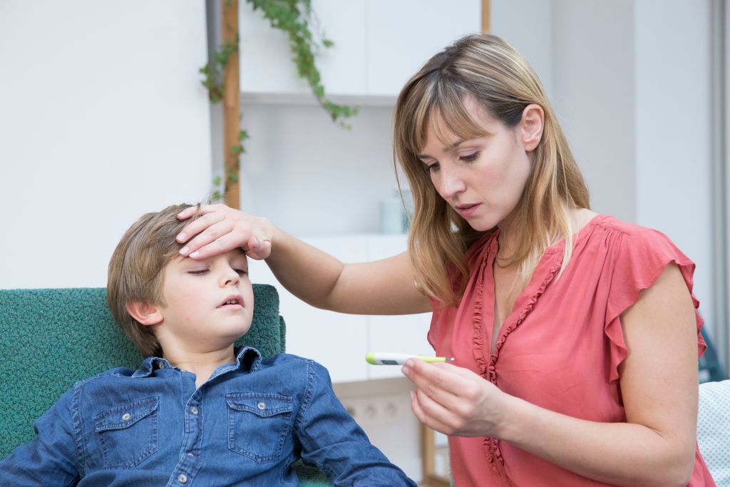 GettyImages-930125092 Mother taking her son's temperature