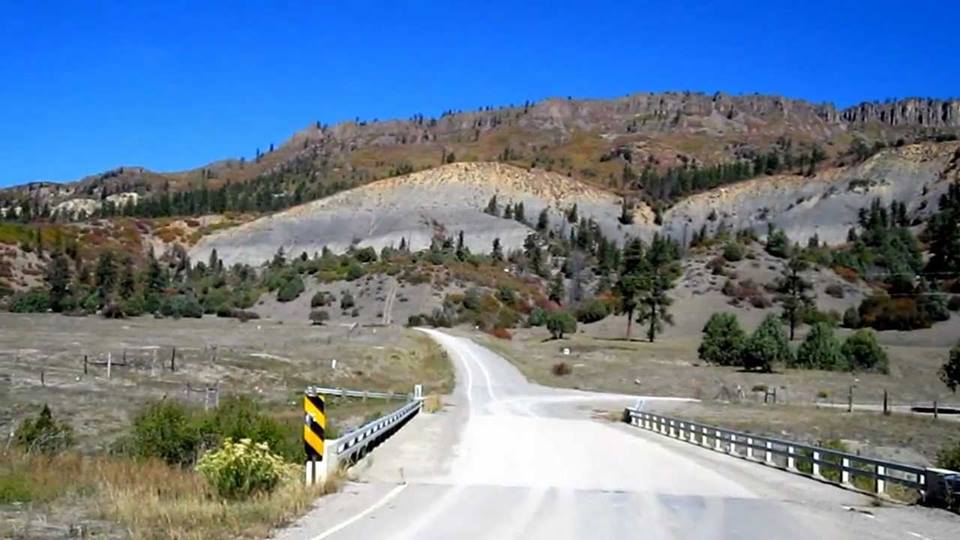 a road winding through hills in Dulce, New Mexico