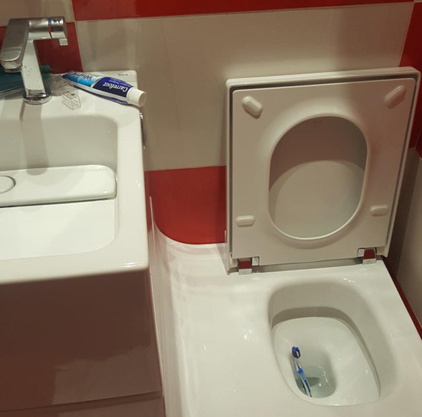 sliding ramp attached to a sink that connects to a toilet 