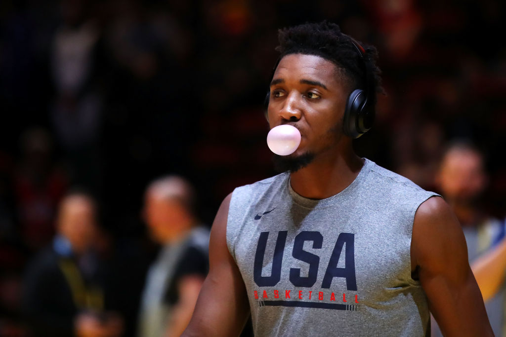 A basketball player blows a bubble with gum