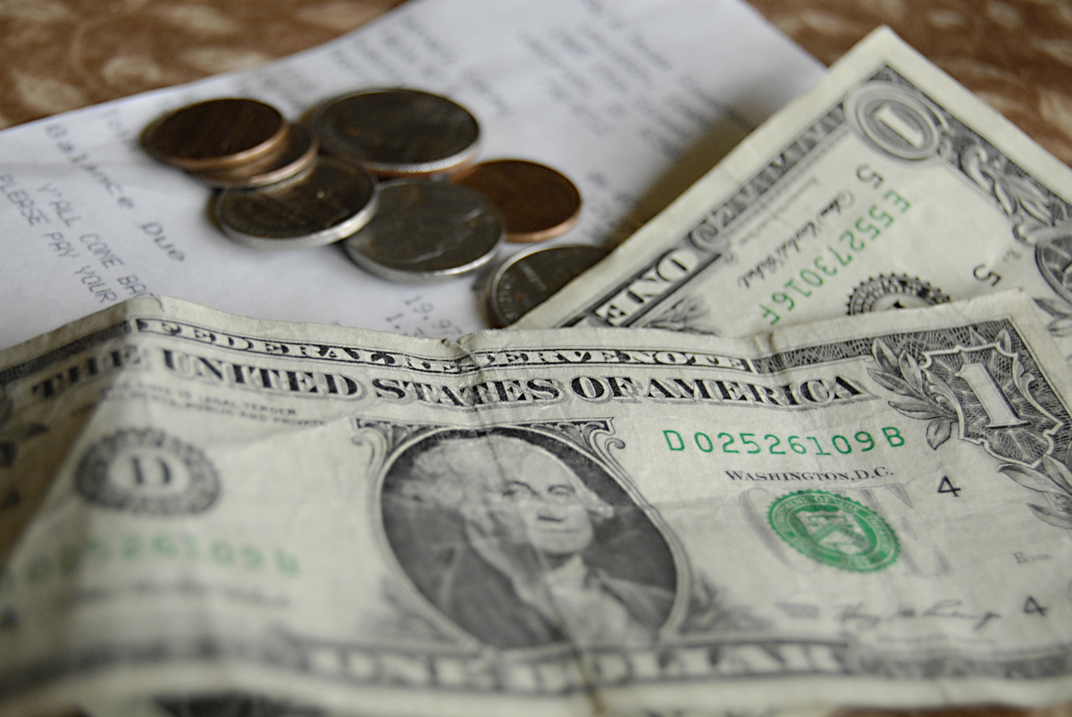 Waiter collecting tip money after check been paid in local american restaurant american econimy 7 une 2012