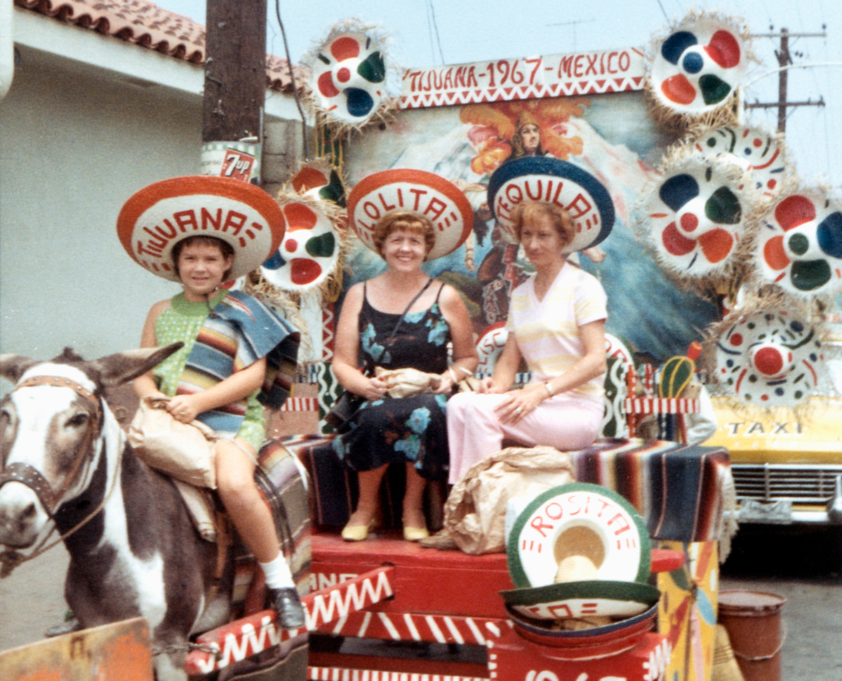An American mother and her two daughters ride in a donkey drawn-tourist cart in 1967. 