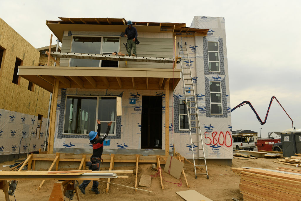 A home under construction is photographed from the backyard
