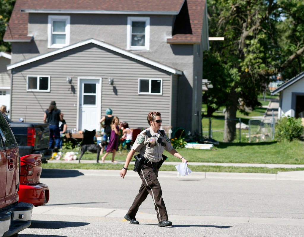 An officer struts down a neighborhood street