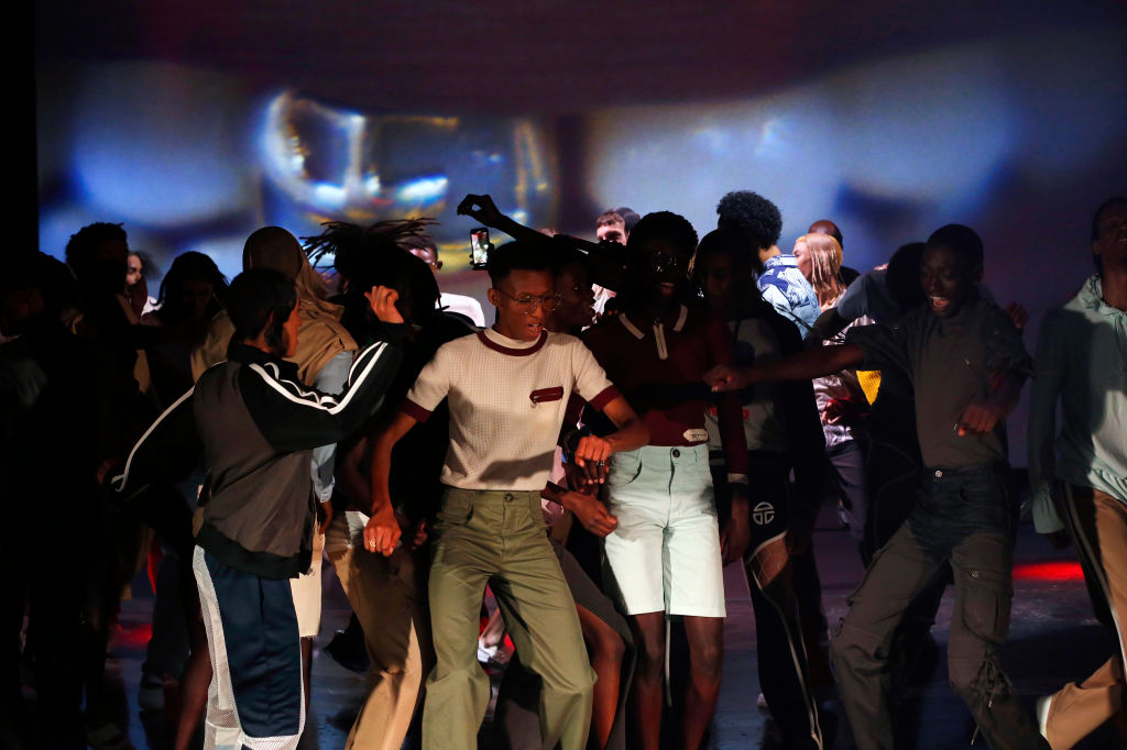 A crowd of dancing people in a dark room