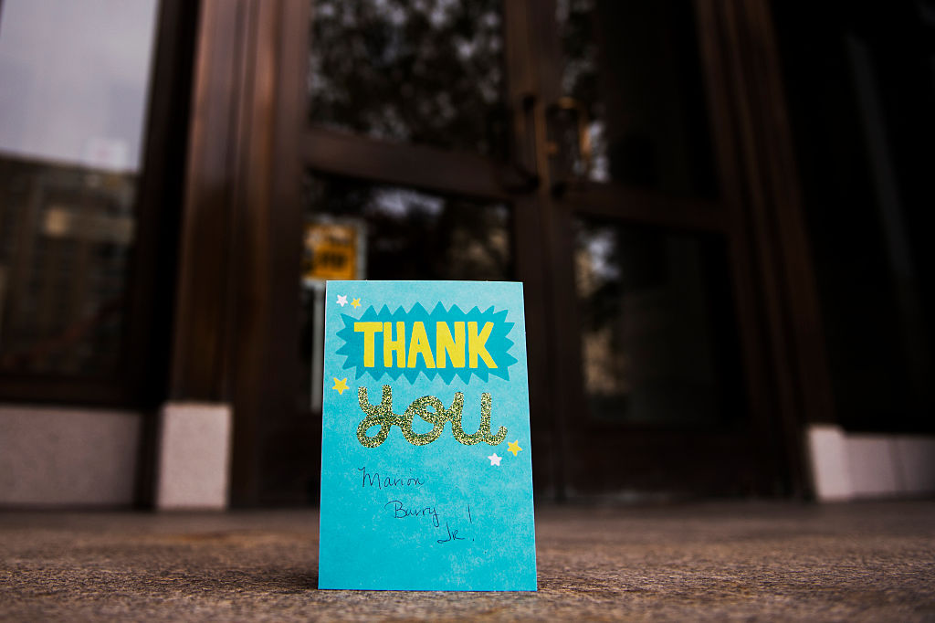 A thank you card is left on a doorstep