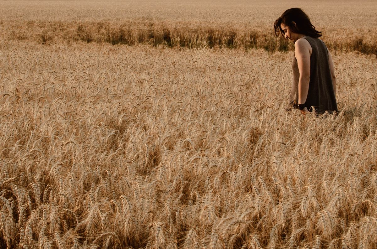 Woman walks through a wheat field in Argentina