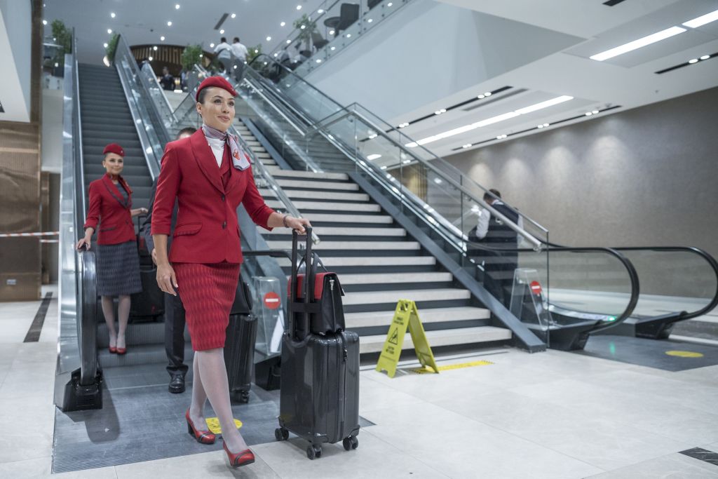 Flight Attendants Exit an Escalator