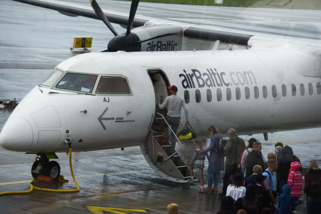 People Board A Plane Outside