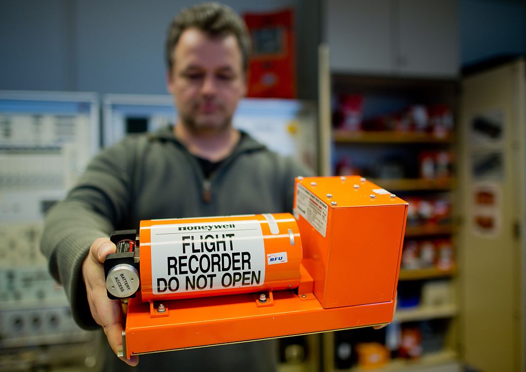 A Man Holds Out A Black Box