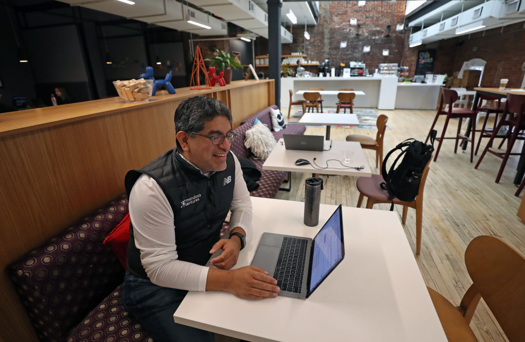 man works in a shared office open area