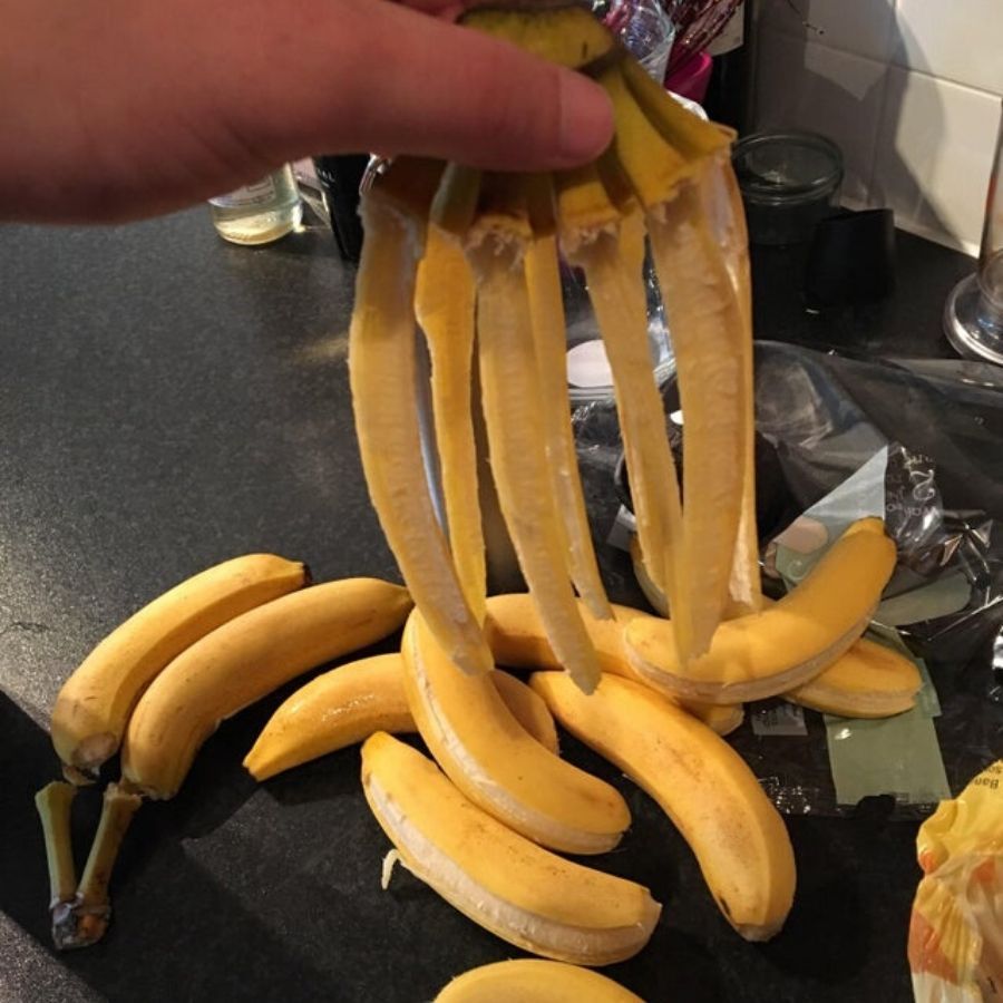 seven bananas that are too ripe and fell off their peels
