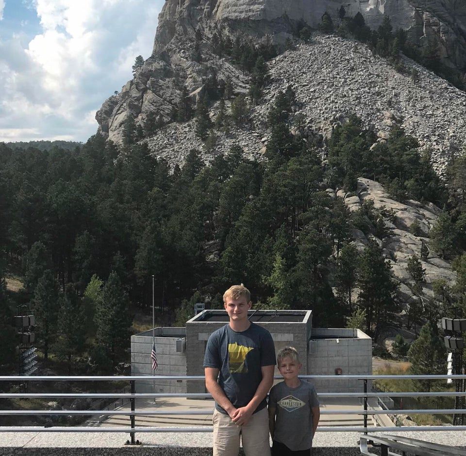 Two people taking photo at mt rushmore with none of the heads visbile