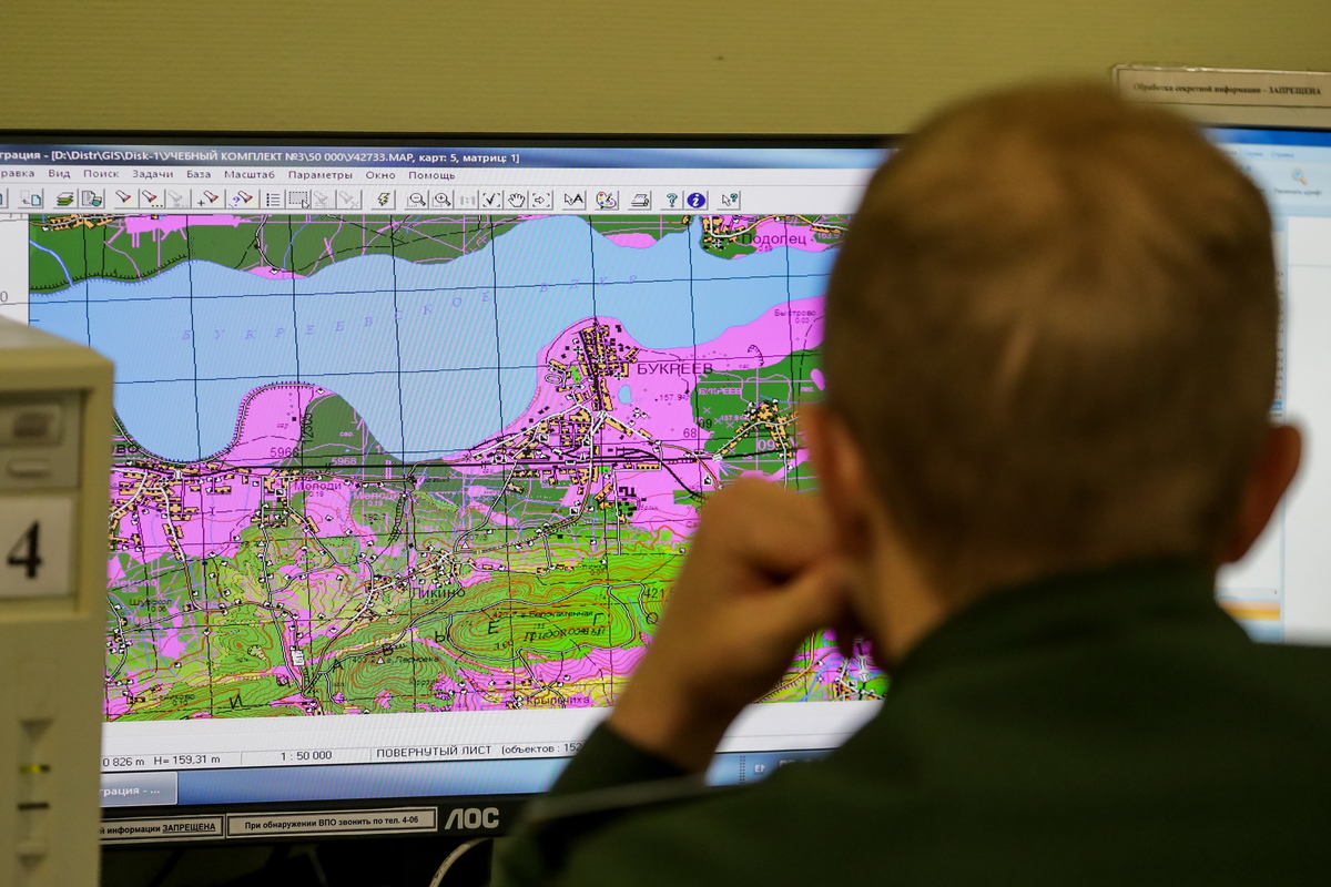 An army student surveys a map during a training exercise.