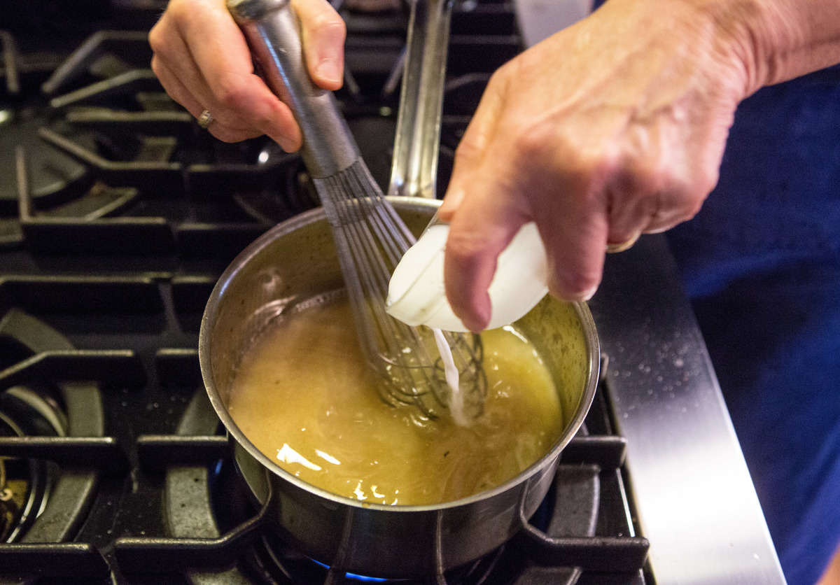 Food editor Sheryl Julian whisks cornstarch diluted with water while making gravy.