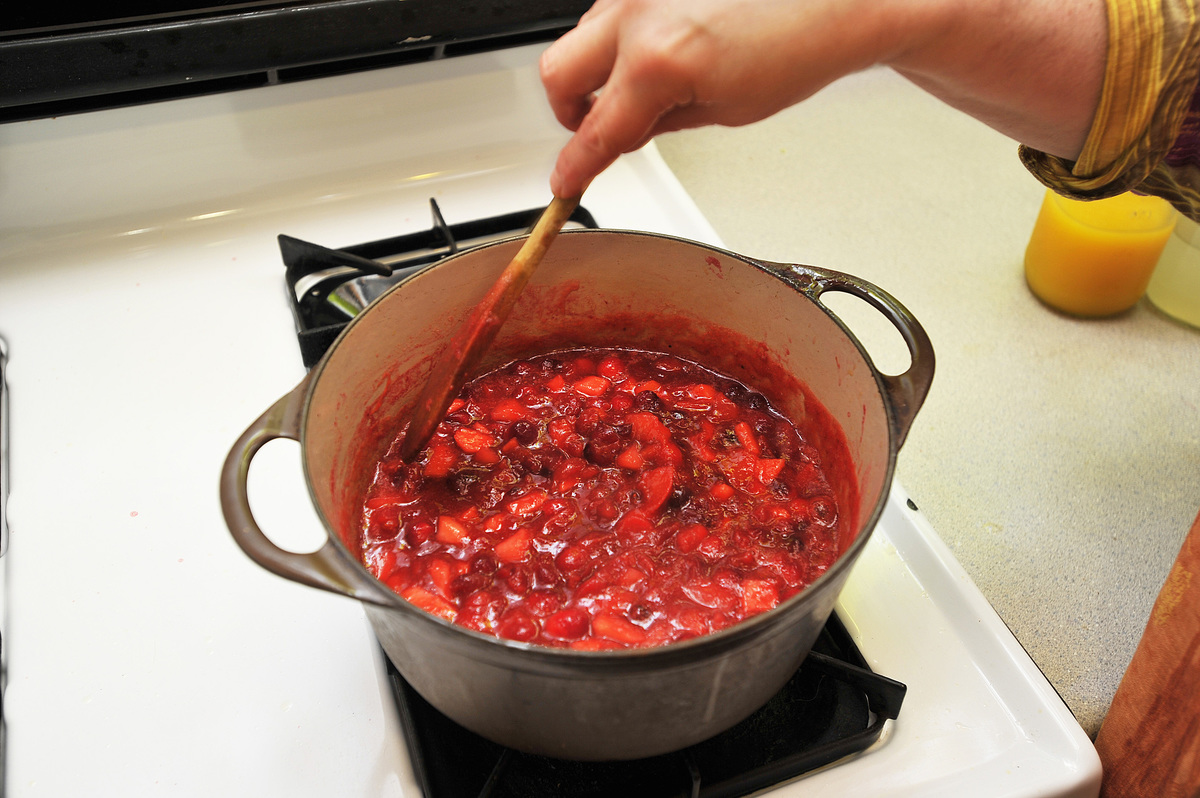 Ellen Cooney stirs her cranberry sauce on the stove.