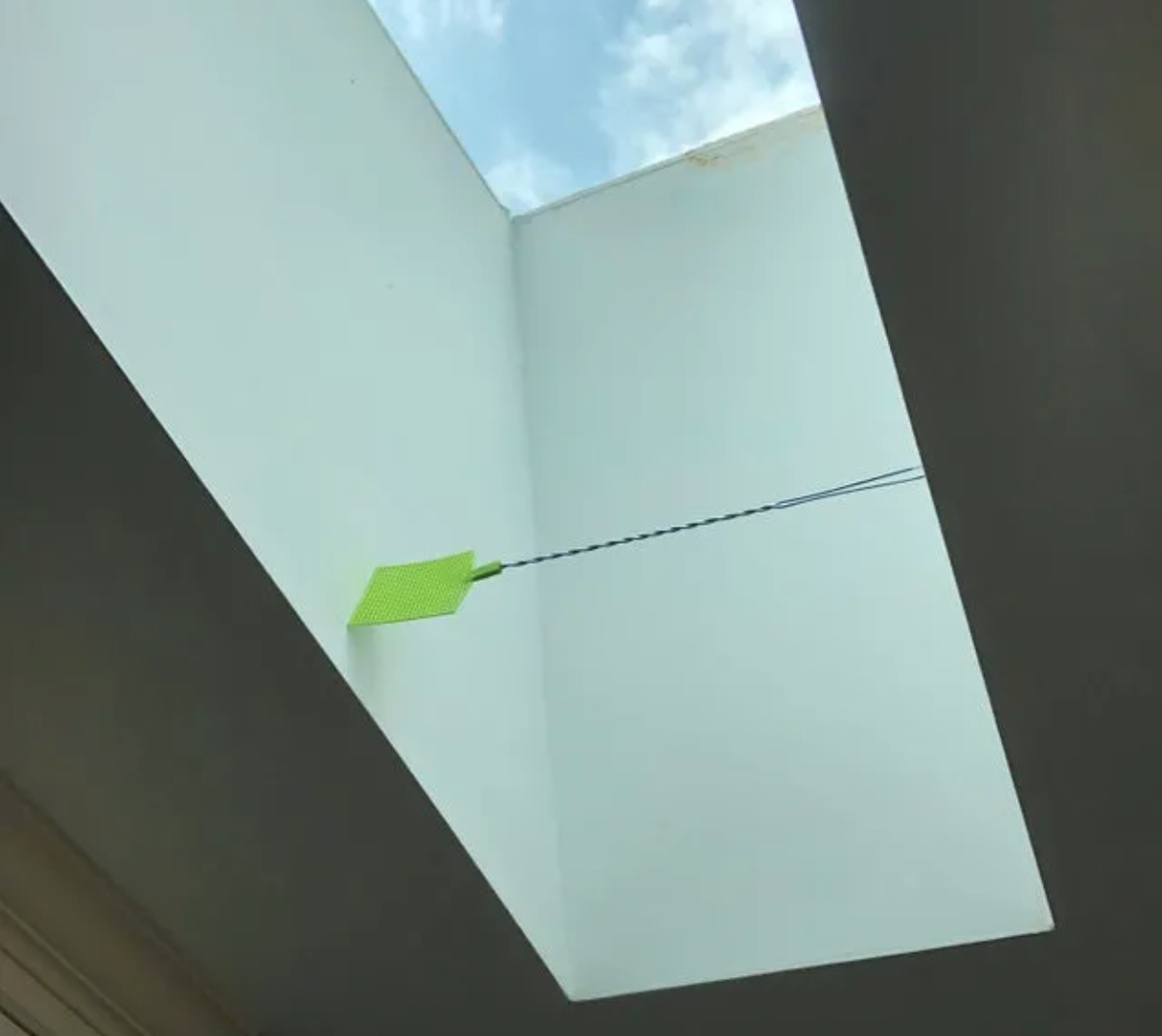 fly swatter trapped in space for skylight