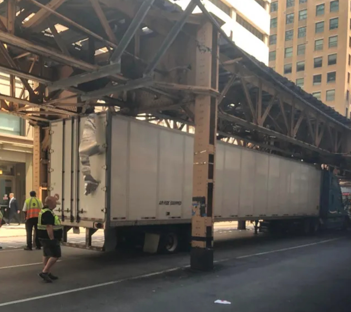 truck tries to go under bridge pass and sheers off top