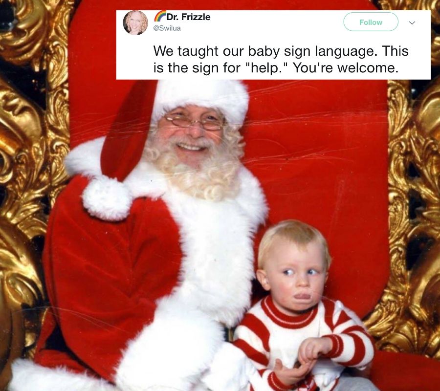 a kid using sign language asking for help off Santa's lap