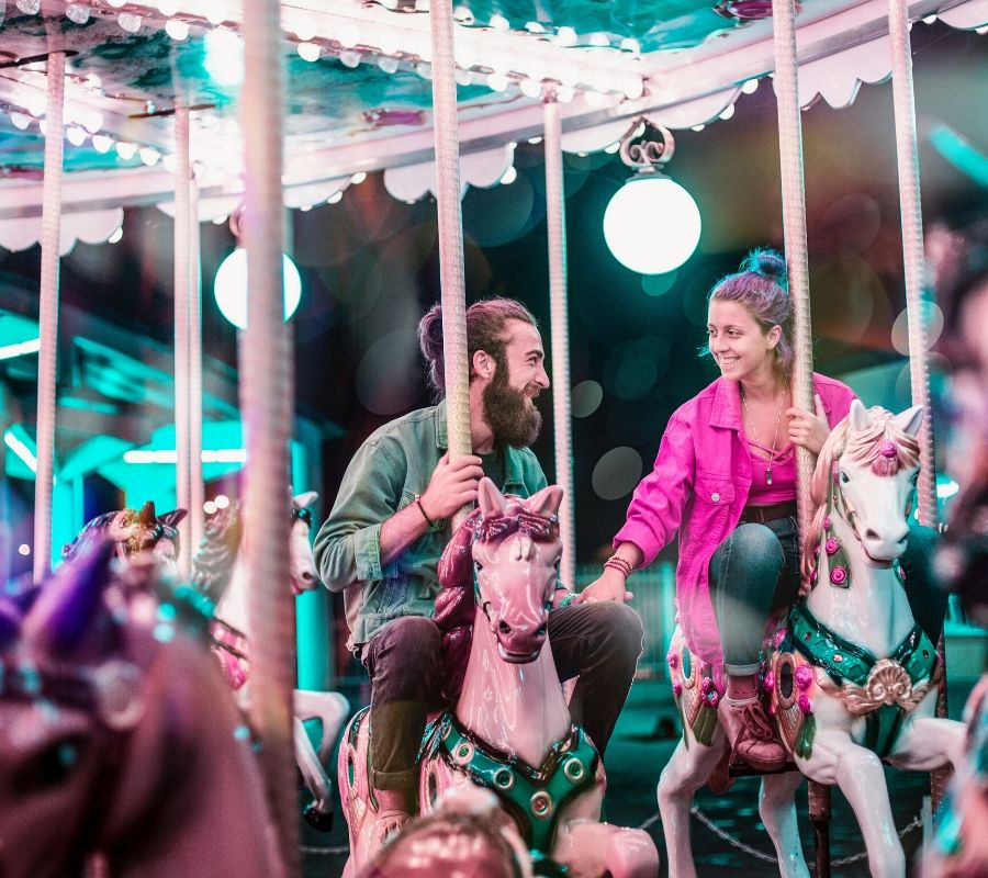 two people on a carousel