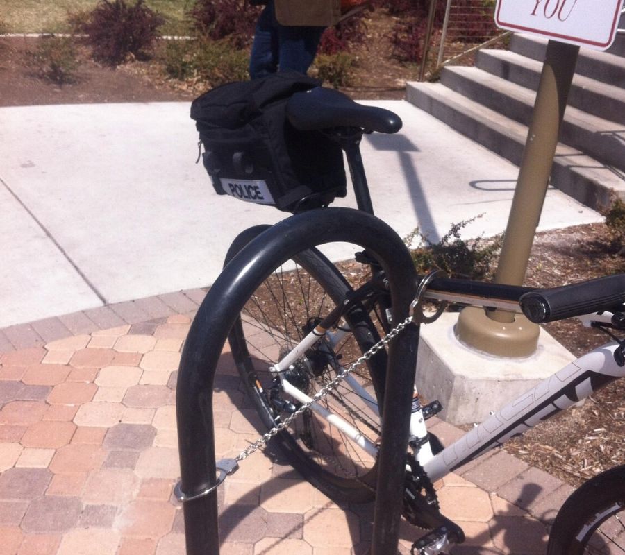 a cop uses cuffs to secure his bike