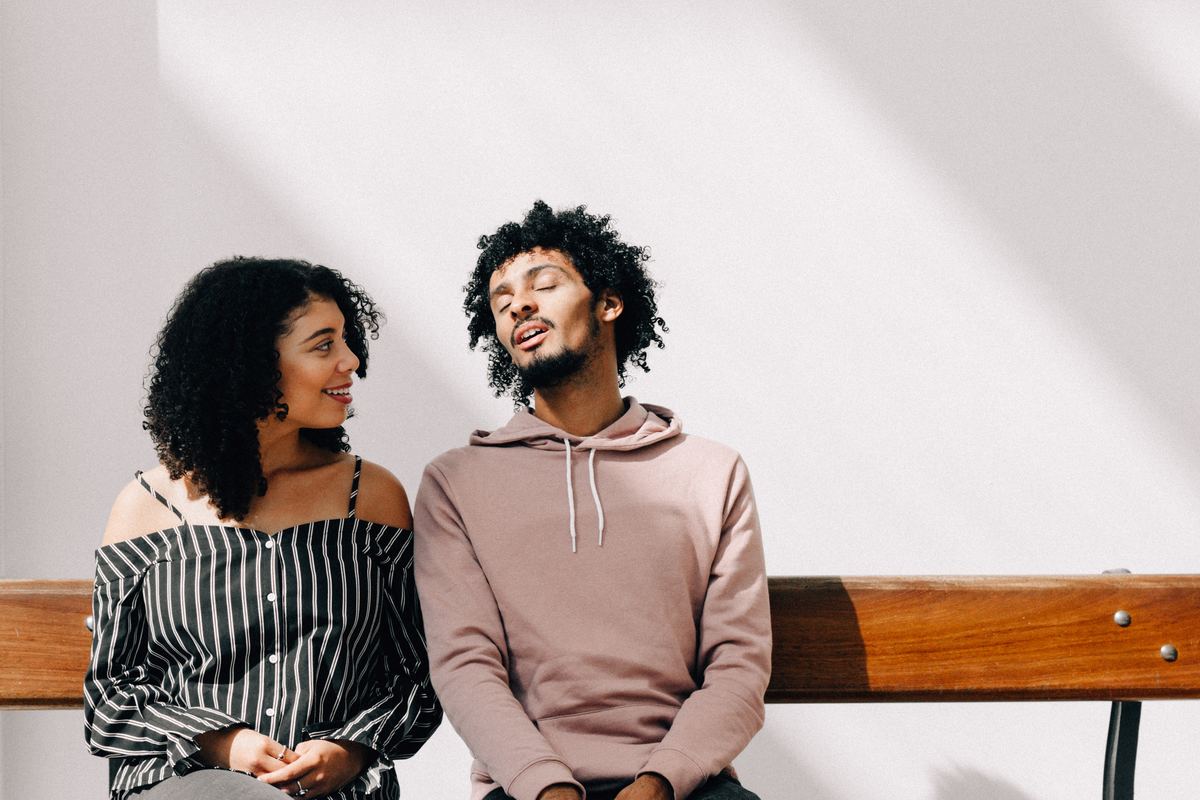 woman looking intently at man on bench