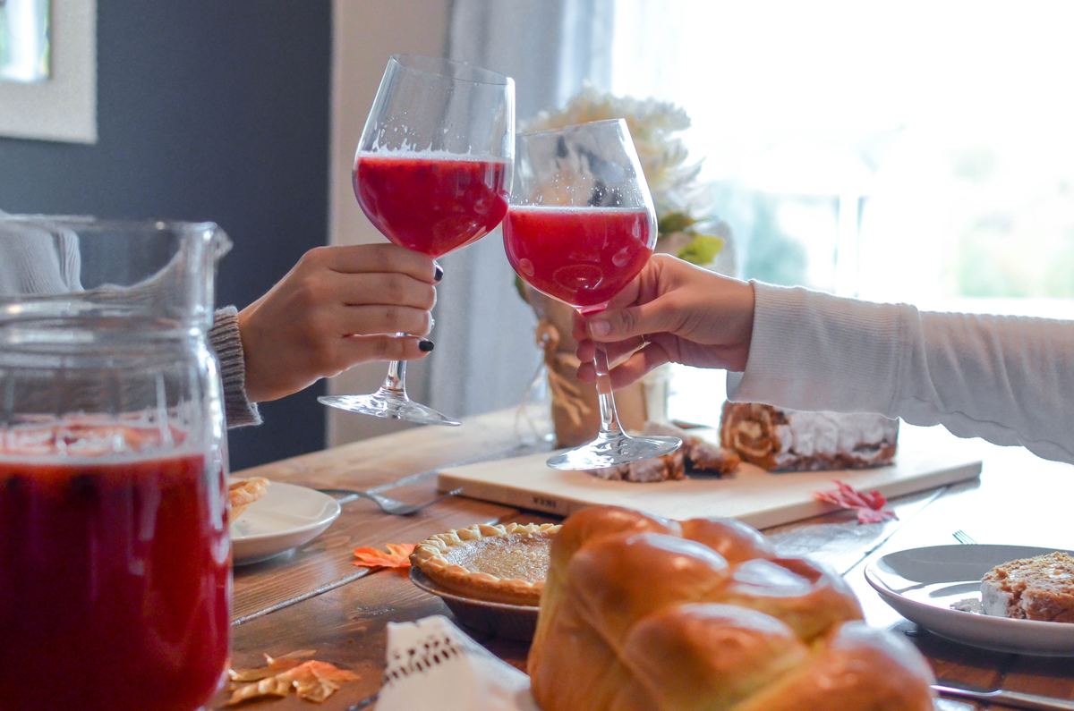 women cheersing glasses at table