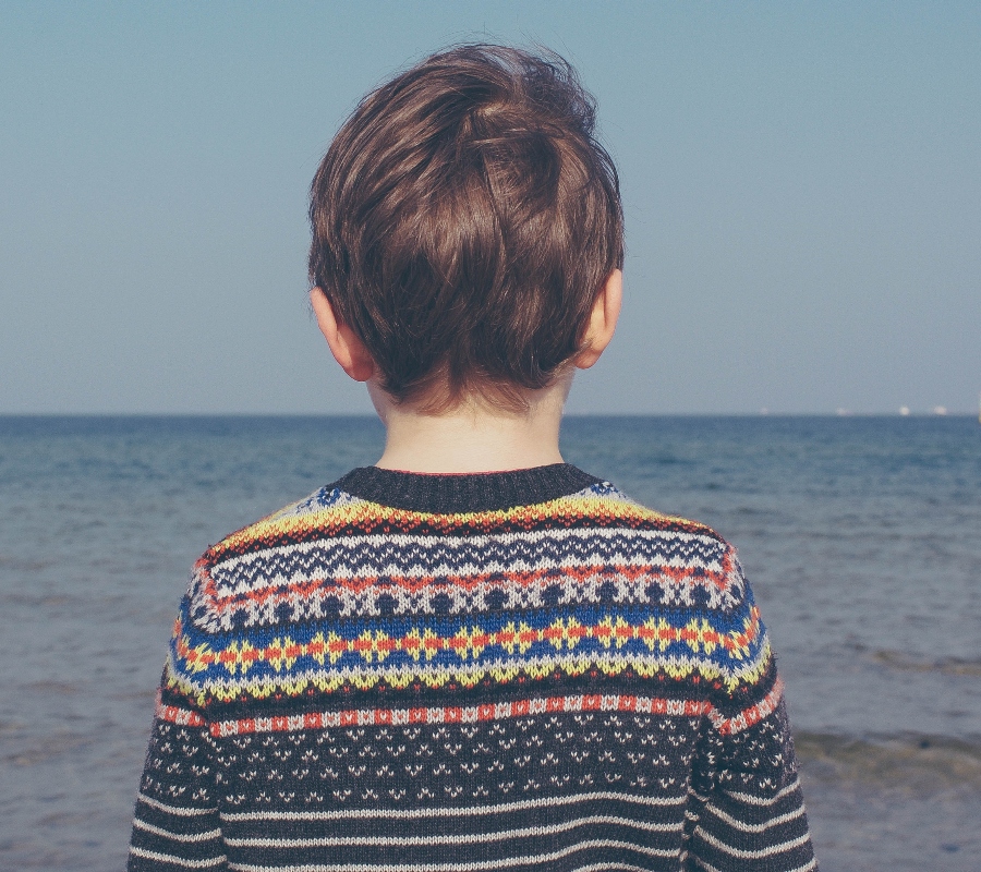 a kid standing on a beach