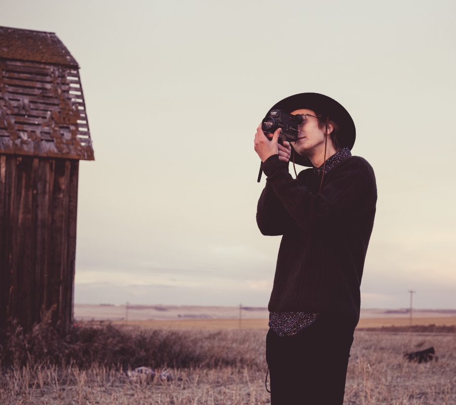 a guy using a video camera 