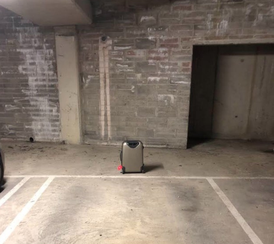 a suitcase left in the parking garage