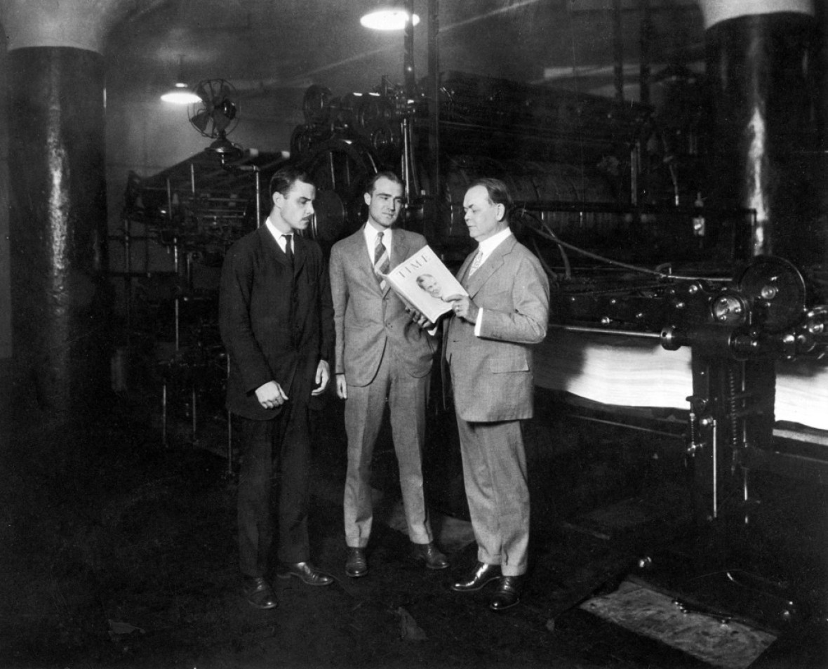 briton hadden and henry luce standing with william r. hopkins holding an issue of time magazine