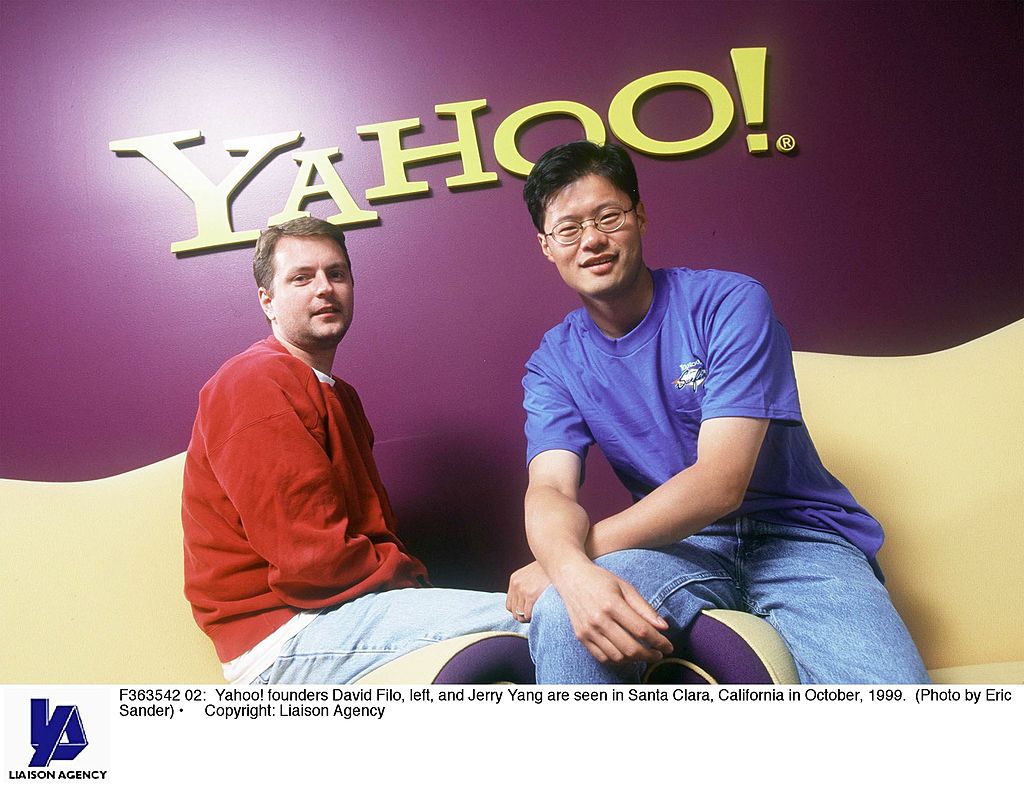 david filo and jerry yang in front of a yahoo! sign