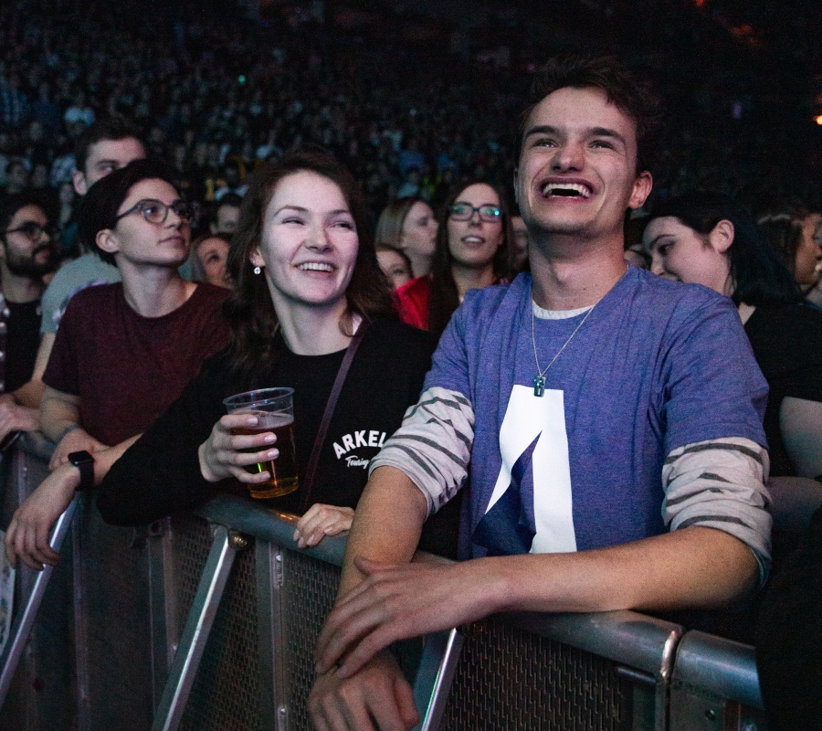 man and woman chilling at concert laughing