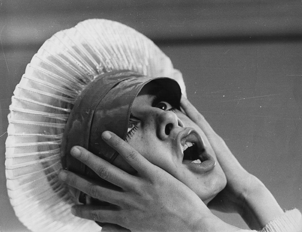 A woman wears an annoyed expression.