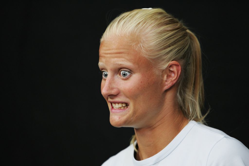 A woman wears a tense expression on her face.