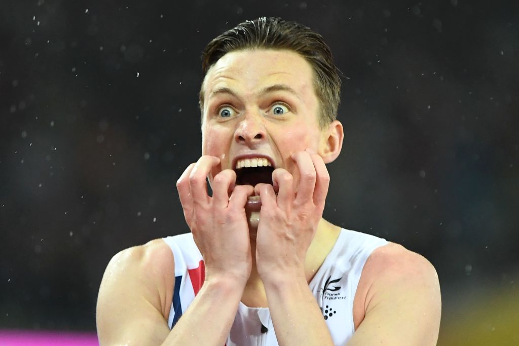 An athlete had wide eyes and an open mouth while hearing the results at a competition.