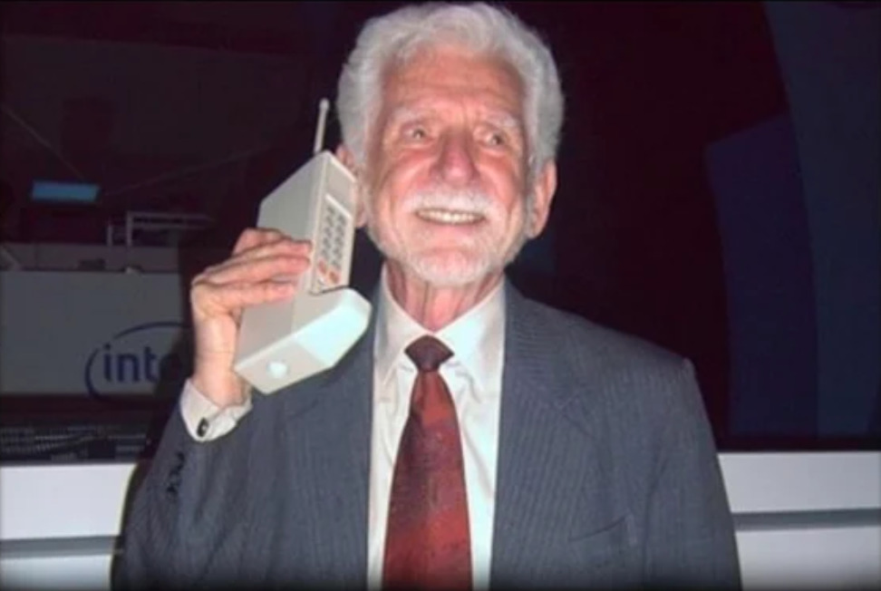 man holding first mobile phone
