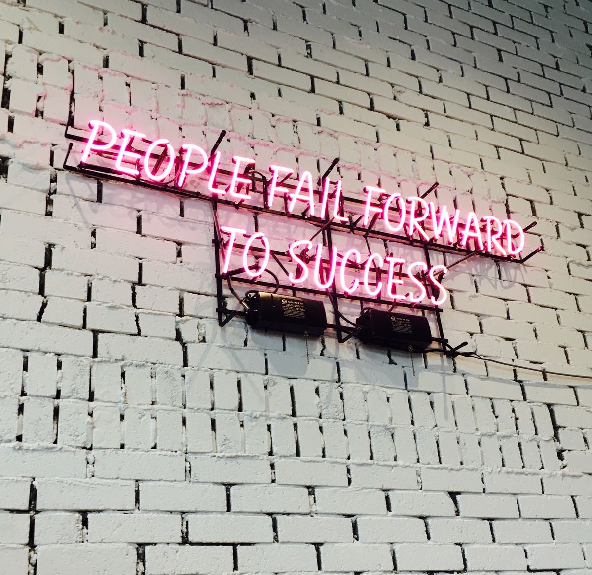 neon sign: PEOPLE FAIL FORWARD TO SUCCESS