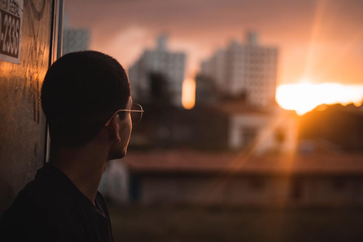 man looking at sunset