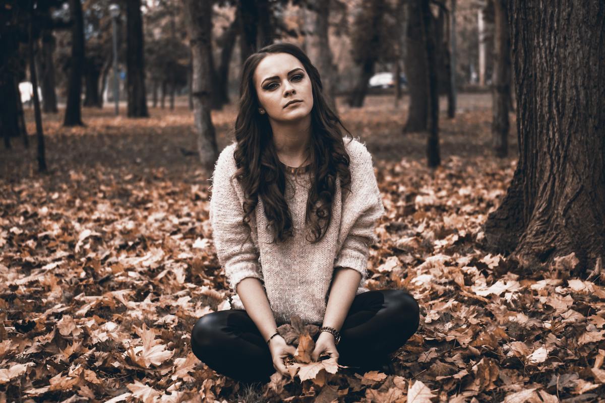 woman sitting in forest 