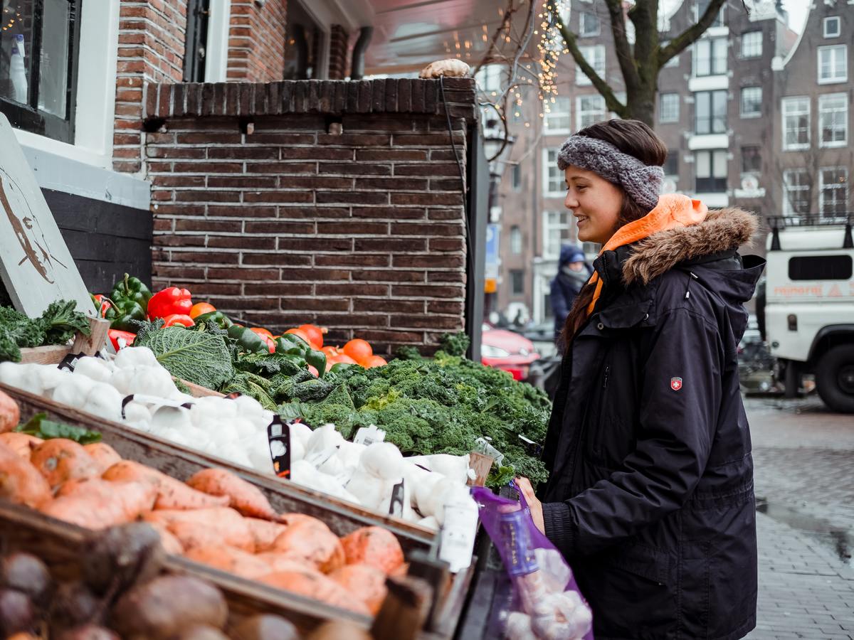 woman standing in front of vegetables