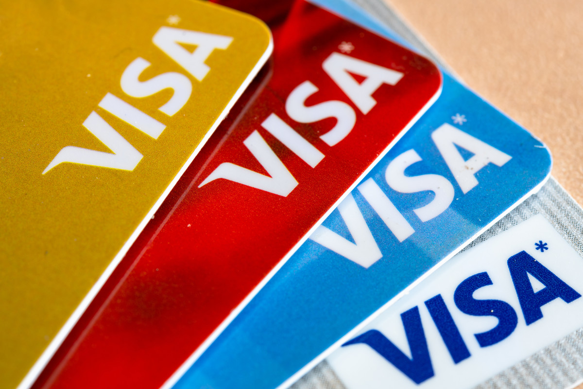 In this photo illustration there are four Visa credit cards...