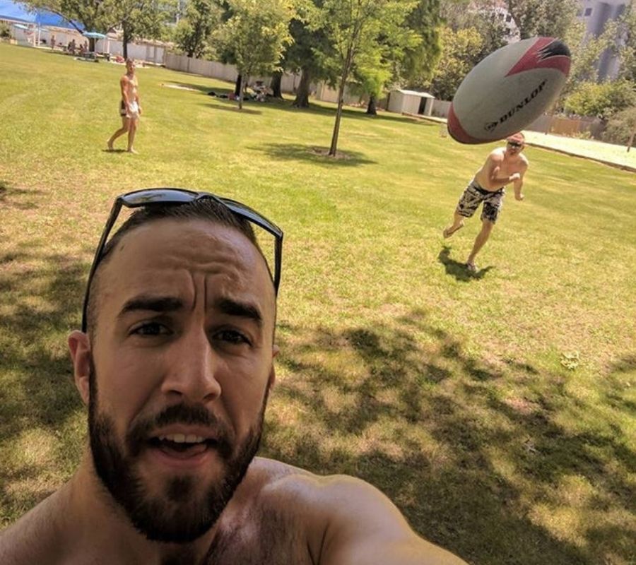 a guy taking a selfie of a football