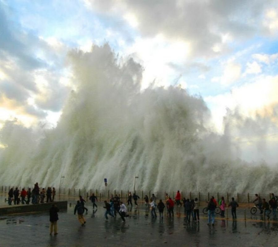 a huge wave coming over the side of a pier