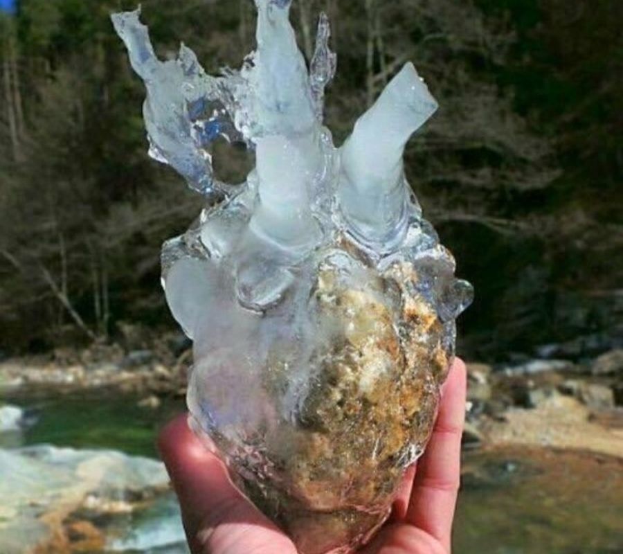 a rock with ice on it that formed like a heart