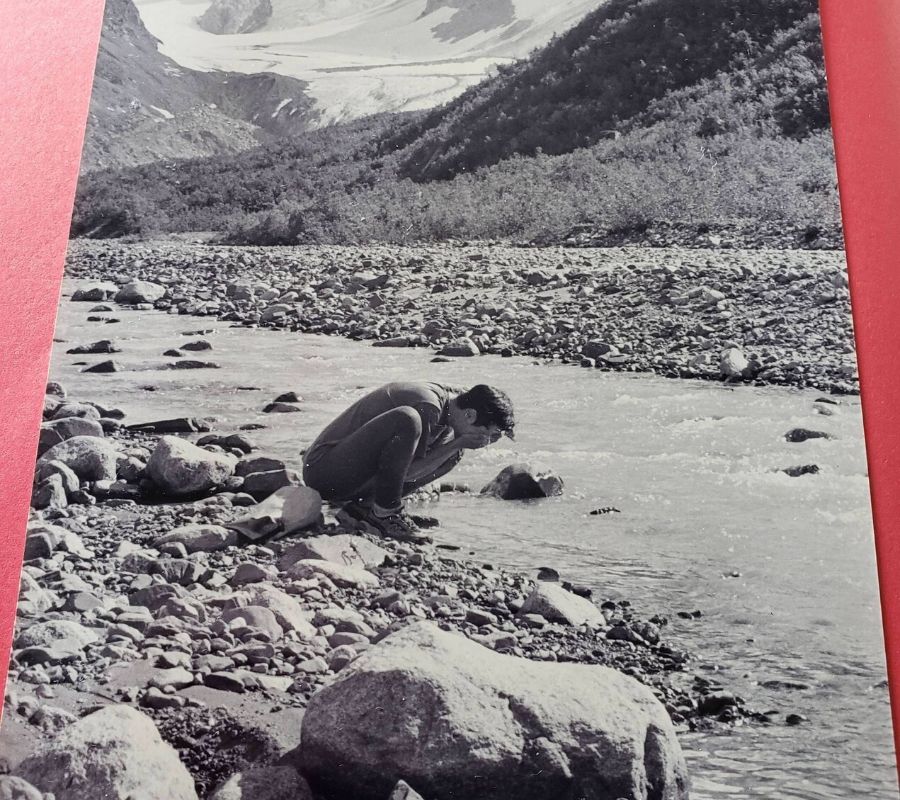 an old picture of someone at a river